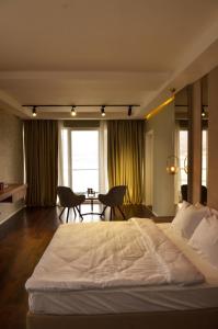 Hotel Cami في ديبار: غرفة نوم بسرير ابيض كبير وطاولة