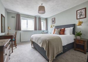 a bedroom with a bed and a dresser and a desk at The New Inn Heckfield in Hook