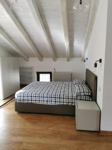 a bedroom with a bed with a checkered blanket at Agriturismo Dai Marchesin in Nasino