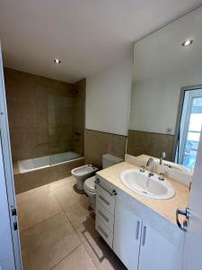 a bathroom with a sink and a toilet and a mirror at Departamento en Corrientes in Corrientes