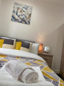 a bedroom with a bed with a towel on it at Urban Retreat - Bradford Apartment Gem in Bradford