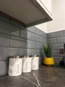 three rolls of toilet paper sitting on a counter at Urban Retreat - Bradford Apartment Gem in Bradford