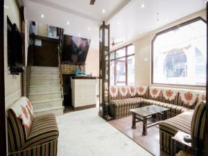 a living room with two couches and a table at Hotel Woodland Deluxe in New Delhi +17 photos