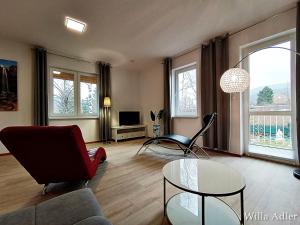a living room with a couch and a table at Willa Adler Ustroń - Spokojna okolica, Blisko cntrum in Ustroń