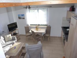 a living room with a table and a couch at Fewo 1 Mittendrin in Lancken-Granitz