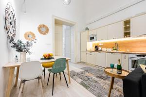 a kitchen and living room with a table and chairs at Mlynska Center Apartment Kosice with private Parking in Košice