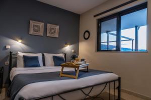 a bedroom with a bed with a table on it at Jo Marinis Rooms in Korinthos