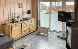 a living room with a dresser with a tv and a couch at 2 Bedroom Nice Home In Rechlin in Rechlin