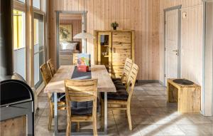 a dining room with a wooden table and chairs at 2 Bedroom Nice Home In Rechlin in Rechlin