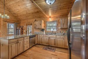 a kitchen with wooden cabinets and a stainless steel refrigerator at Cozy Blue Ridge Cabin in Heart of the Mountains in Blue Ridge