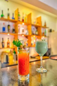 a drink and a wine glass sitting on a counter at The Boho, Vagator Beach Goa Near Thalassa in Anjuna