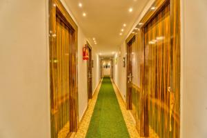 a corridor with a green floor in a building at The Boho, Vagator Beach Goa Near Thalassa in Anjuna