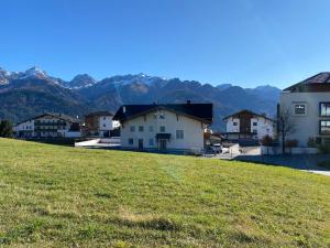 un grupo de casas en una colina con montañas en el fondo en Alpenglück, en Fiss