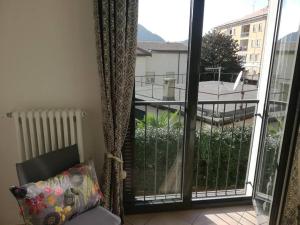 a room with a balcony with a view of a building at La Casa di David in Como