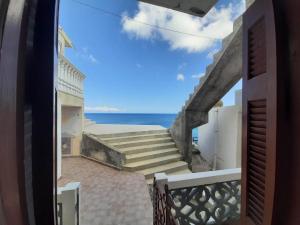 a view from the balcony of a house with stairs at Mare Blu Sole in Karpathos