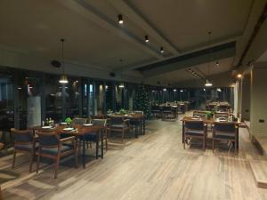 德巴尔Hotel Cami的餐厅设有木桌和椅子,并拥有圣诞树