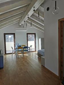 a living room with a table and chairs and a bed at Agriturismo Dai Marchesin in Nasino