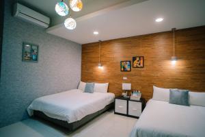 Voodi või voodid majutusasutuse 屏東潮州民宿-綠品文旅Green Inn toas