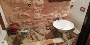 a bathroom with a sink and a toilet at La Casa Sù Le Dimore Del Borgo in Santo Stefano di Sessanio