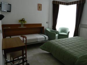Ένα ή περισσότερα κρεβάτια σε δωμάτιο στο Residence Dei Fiori