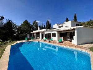 a large swimming pool in front of a house at Portimão Bellevue Villa With Pool by Homing in Portimão