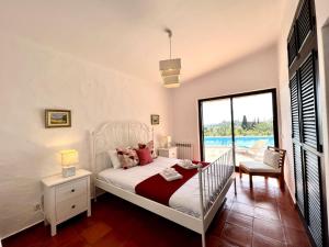 a bedroom with a bed and a view of a pool at Portimão Bellevue Villa With Pool by Homing in Portimão +39 photos
