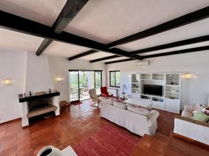 a living room with white furniture and a fireplace at Portimão Bellevue Villa With Pool by Homing in Portimão