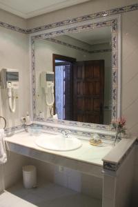 a bathroom with a sink and a large mirror at Vettonia in Ávila