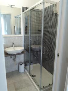 a bathroom with a glass shower and a sink at Suite in Città residence in Isernia