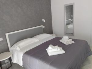 a bedroom with a bed with two towels on it at Suite in Città residence in Isernia