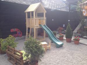 a playground with a slide and some plants at Penzion Javorina in Čičmany