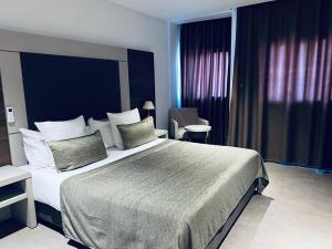 ein Schlafzimmer mit einem großen Bett in einem Zimmer in der Unterkunft Grand Hotel Central Conakry in Conakry
