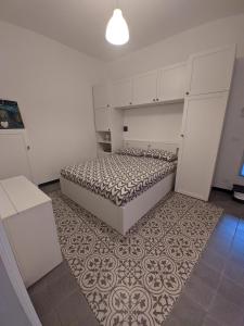ein kleines Schlafzimmer mit einem Bett und einem Teppich in der Unterkunft Casa di Nico in Finale Ligure