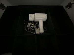 a black table with a white hair dryer on it at Sweet Loft Homestay in Johor Bahru