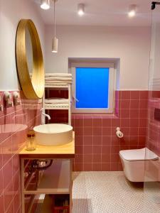 a bathroom with a sink and a toilet and a window at Apartamento PC in Torrelavega
