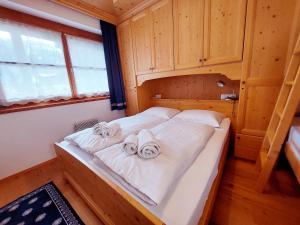 a bedroom with a bed with towels on it at Apartment MEISE in Bad Kleinkirchheim