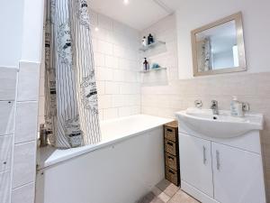 a white bathroom with a sink and a shower at Cool Place 02 Academy in London