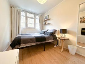 a bedroom with a bed and a window and a table at Cool Place 02 Academy in London