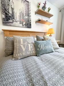 a bedroom with a bed with pillows on it at Cool Place 02 Academy in London