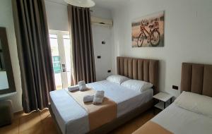 Postel nebo postele na pokoji v ubytování Hotel de Ksamil