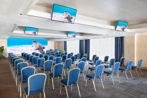 a room with rows of chairs and televisions at Courtyard by Marriott Rome Central Park in Rome