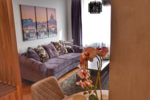 a living room with a couch and a table at Blaumana Residence Apartments in Riga