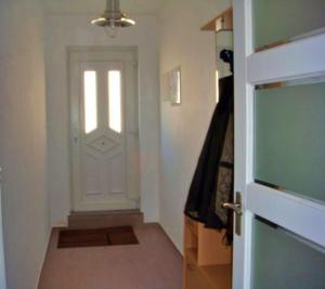a hallway with a white door with a window at 4 Persoons Woning met Zwembad. Rustig gelegen. in Figueira e Barros
