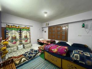 a bedroom with two beds in a room at Kareri Kommune- The Last House in Dharamshala