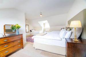 a bedroom with a bed and a dresser with a mirror at Screebe House in Rosmuck