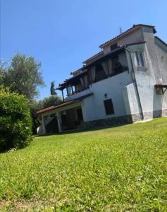 a house with a green lawn in front of it at Villa house Beach house N Hrakleia Xalkidikis No4 in Nea Iraklia