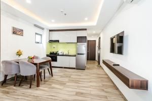 a kitchen and dining room with a table and chairs at SWEDEN HOTEL and APARTMENT in Danang