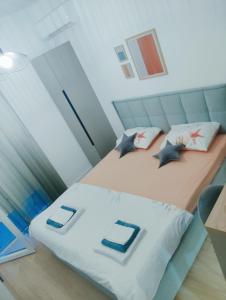 a bedroom with two beds with pillows at Apartman Iskra in Trebinje