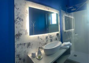 a bathroom with a sink and a mirror at Residenza “La Vecchia Ancora” in Castelsardo +53 photos