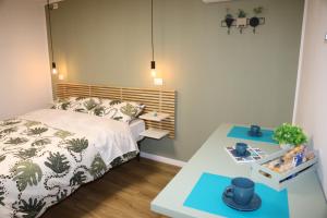 a small bedroom with a bed and a table at Casa Viscardi in Naples